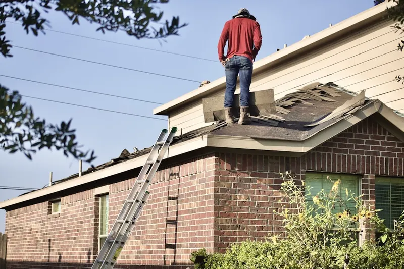 Professional roofer working on a residential roof in Maine